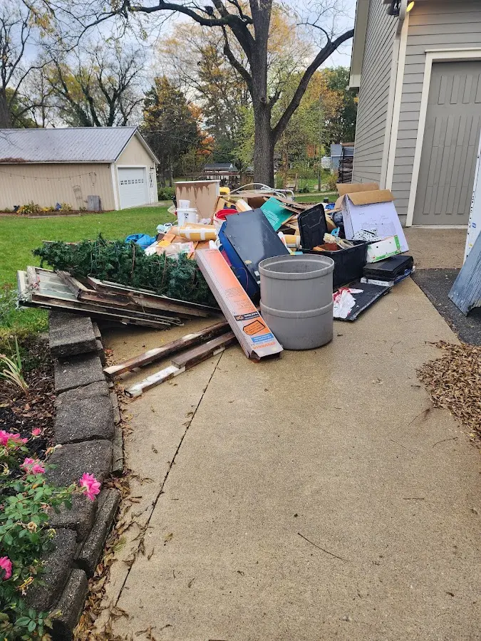 Dumpster being loaded with debris for Estate Cleanout Dumpster Rental in Holton